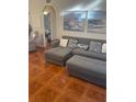 Comfortable living room featuring a gray sofa and patterned pillows at 1031 Tony Cir, St Cloud, FL 34772