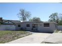Lovely single-story home featuring a spacious driveway and cozy front porch at 1103 Malcom Rd, Ocoee, FL 34761