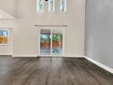 Bright living space featuring wood floors and sliding glass doors leading to the patio at 1118 Meditation Loop, Port Orange, FL 32129