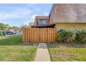 Quaint home with a wooden fence, walkway and well-maintained front yard at 116 Moonstone Ct, Port Orange, FL 32129