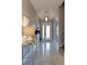 Elegant foyer with marble floors, modern lighting, and decorative console table at 1204 Draycott St, Ormond Beach, FL 32174