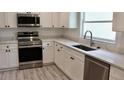 Renovated kitchen featuring white cabinetry, stainless appliances, and a modern faucet at 1275 16Th St, Orange City, FL 32763