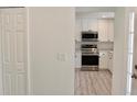 View of modern kitchen boasting white cabinets and stainless steel appliances at 1275 16Th St, Orange City, FL 32763