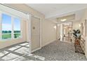 Elegant hallway with patterned carpet, stylish lighting, and a view of the outdoors at 1925 S Atlantic Ave # 201, Daytona Beach, FL 32118