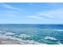 Breathtaking ocean view with blue water and a sandy beach in the distance at 1925 S Atlantic Ave # 201, Daytona Beach, FL 32118