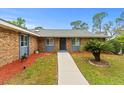 Well maintained single-story brick home featuring a well-maintained lawn and cozy front entrance at 1957 Monterey Dr, Deltona, FL 32738