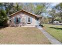 Charming home featuring light-colored siding, blue shutters, and flower boxes under the windows at 201 W Central Ave, Orange City, FL 32763