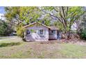 Charming home featuring light-colored siding, blue shutters, and flower boxes under the windows at 201 W Central Ave, Orange City, FL 32763