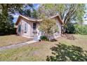 Charming home featuring light-colored siding, blue shutters, and flower boxes under the windows at 201 W Central Ave, Orange City, FL 32763