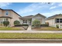 Charming one-story home featuring manicured landscaping and a well-maintained front yard at 203 W Tarrington Dr, Deland, FL 32724