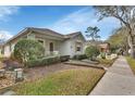 Charming one-story home featuring manicured landscaping and a well-maintained front yard at 203 W Tarrington Dr, Deland, FL 32724