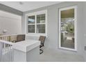 Inviting front porch with seating area, perfect for enjoying the outdoors at 203 W Tarrington Dr, Deland, FL 32724