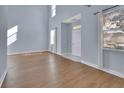 Bright living room featuring hardwood floors, tall ceilings, and an inviting entryway at 214 Woodhouse Ln, Deland, FL 32724