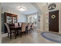 Formal dining area with a large window, elegant lighting, and seating for eight at 2344 Kelbrook Ct, Oviedo, FL 32765