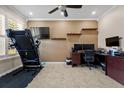 Functional home office with a ceiling fan, built in shelving, and ample workspace at 2344 Kelbrook Ct, Oviedo, FL 32765