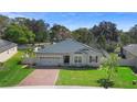 Well-maintained home with brick driveway and manicured lawn at 2393 Oxmoor Dr, Deland, FL 32724