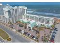 Scenic aerial shot of a beachfront resort with palm trees and parking at 2700 N Atlantic Ave # 454, Daytona Beach, FL 32118