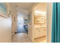 Bright hallway leading to a bedroom and bathroom with white tile floors at 2700 N Atlantic Ave # 454, Daytona Beach, FL 32118