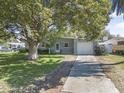 Single-story home with a driveway and a well-manicured front lawn at 2821 Oak Lea Dr, South Daytona, FL 32119