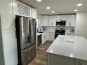 Modern kitchen with large island, stainless steel fridge, and white cabinets at 2929 Carriage Dr, South Daytona, FL 32119