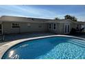 Inviting in-ground pool with cool blue water and brick-paved patio at 2929 Carriage Dr, South Daytona, FL 32119