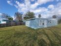 Charming light blue single-story home with white trim, windows, and a large, well-kept lawn at 305 Elsie Ave, Daytona Beach, FL 32117