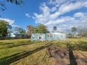 Exterior view of a charming light blue single-story home with white trim and a spacious yard at 305 Elsie Ave, Daytona Beach, FL 32117