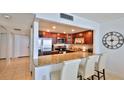 Open kitchen with granite countertops and stainless steel appliances overlooking the living area at 3051 S Atlantic Ave # 2206, Daytona Beach, FL 32118