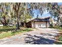 Exterior view of a home with a two-car garage, showcasing a concrete driveway and stone accents at 4612 Reynosa Sw Dr, Winter Haven, FL 33880