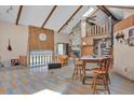 Open living space with high ceilings, exposed beams, a stone fireplace, and a unique tile floor design at 4612 Reynosa Sw Dr, Winter Haven, FL 33880