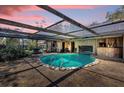 Relaxing covered pool area featuring a unique bar, clear water, and ample space for entertaining at 4612 Reynosa Sw Dr, Winter Haven, FL 33880