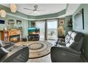 Comfortable living room with a fireplace, large TV, and a view of the ocean at 4670 Links Village Dr # B706, Ponce Inlet, FL 32127