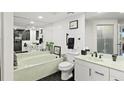 Elegant bathroom featuring dual sinks, a tub, and modern fixtures and decor at 521 Marina Point Dr # 521, Daytona Beach, FL 32114