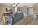 Comfortable living room with a modern gray sofa, ceiling fan, and stylish decor at 605 Anderson Dr, Deltona, FL 32725