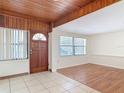 Bright living room boasting tile and wood flooring, and neutral walls with windows at 61 West Highbanks, Debary, FL 32713
