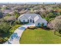 Expansive aerial view of a single-story home with lush green lawn and mature trees at 65 Calumet Ave, Ponce Inlet, FL 32127
