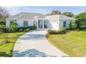 Charming single-story home with lush front lawn, inviting entrance, and attached garage in a desirable neighborhood at 65 Calumet Ave, Ponce Inlet, FL 32127