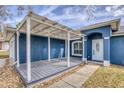 A covered front porch with a trellis roof offering curb appeal and outdoor living space at 711 Hiview Cir, Port Orange, FL 32127