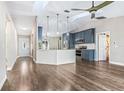Open-concept living area with a modern kitchen, stylish island and seamless flow at 711 Hiview Cir, Port Orange, FL 32127