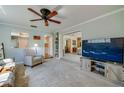 Comfortable living room featuring plush carpet, a ceiling fan, and an entertainment center at 901 Ponca Trl, Maitland, FL 32751