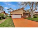 Inviting single Gathering home featuring a two-car garage and charming front porch with decorative columns at 926 Sycamore St, Daytona Beach, FL 32114