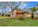 Charming single Gathering home with a two-car garage, decorative columns, and a well-maintained lawn at 926 Sycamore St, Daytona Beach, FL 32114