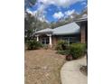 A cozy single-Gathering home with tidy landscaping, complemented by mature trees and a welcoming walkway at 961 Oakwood Rd, Orange City, FL 32763