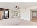 Cozy living room featuring a ceiling fan and sliding glass doors that open to a balcony at 1 Oceans West Blvd # 1B2, Daytona Beach, FL 32118