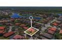 Aerial view of a residential area with houses, tree coverage, and ponds at 100 Via Rosa Ct, Debary, FL 32713