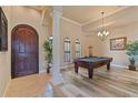Spacious game room featuring a pool table, wood floors, and large windows for natural light at 100 Via Rosa Ct, Debary, FL 32713