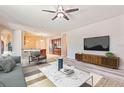 Bright living room featuring modern furniture and a view to the kitchen at 100 Via Rosa Ct, Debary, FL 32713
