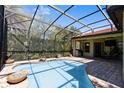 Screened-in pool with a brick deck and views of the backyard at 100 Via Rosa Ct, Debary, FL 32713