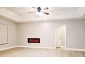 Bright living room featuring a modern electric fireplace and wood-look flooring at 1013 Matterhorn St, Deltona, FL 32725