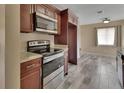 Updated kitchen with stainless steel appliances and stylish wood-look tile flooring at 1033 Windbrook Dr, Deltona, FL 32725